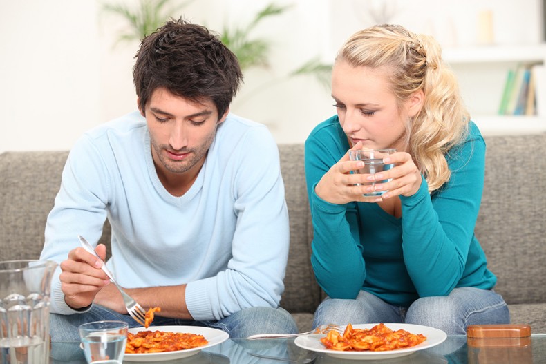 Couple having dinner on the sofa