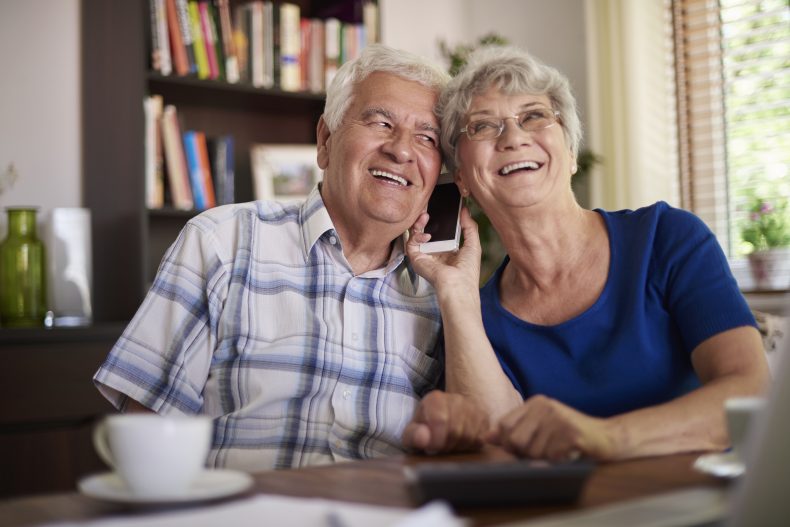 Grandparents talking on the phone at the table